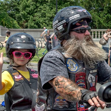 Child and adult on Harley motorcycle for annual Rolling Thunder event in Washington, D.C.