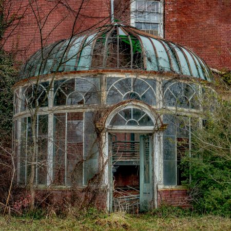 Abandoned mansion green house with domed glass roof.