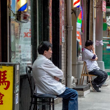 Chinatown, New York barbers waiting for business.