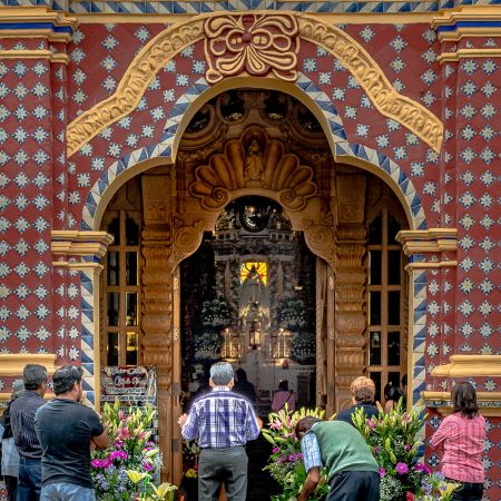 Puebla, Mexico parishioners carrying flowers into church of Santa Maria Tonantzintla.