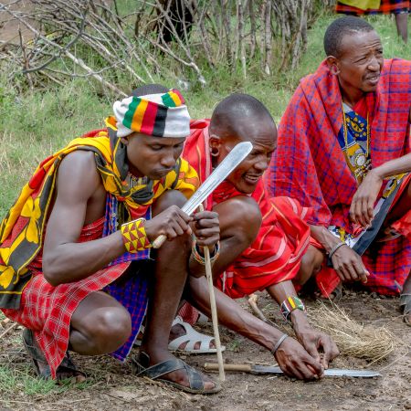 Maasai Warriers creating fire by hand.