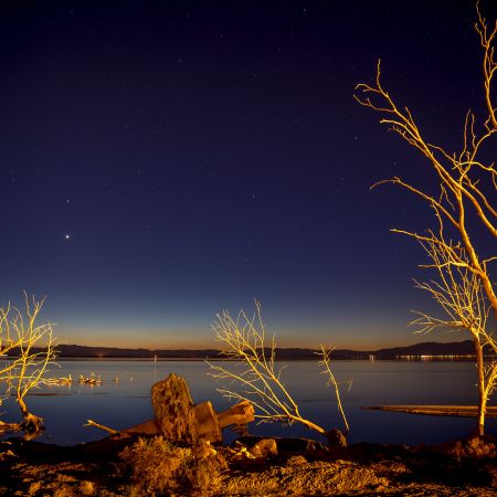 Nightscape of Salton Sea, California, with golden illumination cast by nearby geothermal plant.