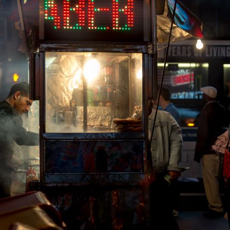 Hot dog and pretzel vendor on New York City street.