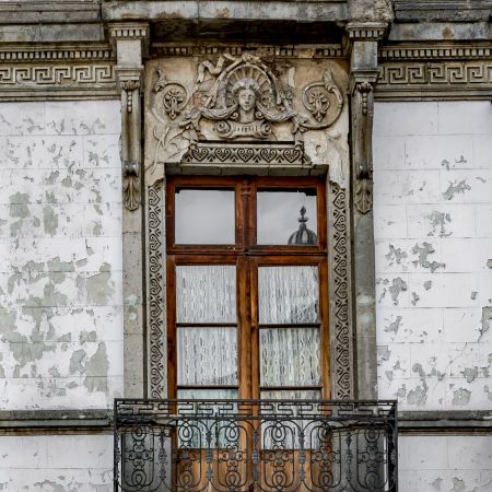 Ornate window with reflection of Mexico City's church.