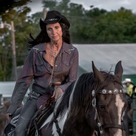 Horsewoman wearing cowboy hat at Maryland rodeo.