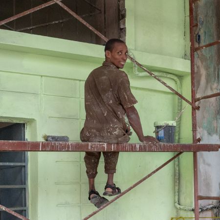 Cuban painter in Havana pausing to smile.