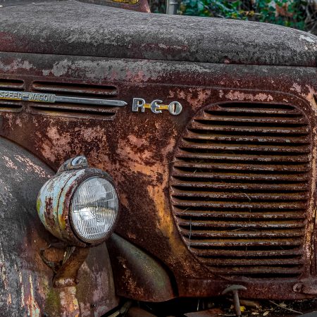 Rusted and peeling classic REO Speedwagon truck.