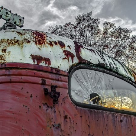 Sunset through the cracked rear window of a 1940s vintage truck.