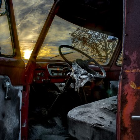 Sunset and the interior of a vintage 1950s truck cab.