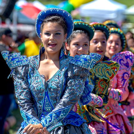 Young women in traditional dress dancing at Pro Bolivian Festival.