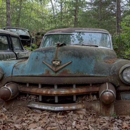 1940s turquoise Cadillac Sedan with winged female hood ornament.