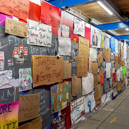 Construction walkway with black lives matter signs posted on walls in the aftermath of George Floyd death.