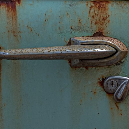 1950s turquoise car rusted door handle and key slot with cover.