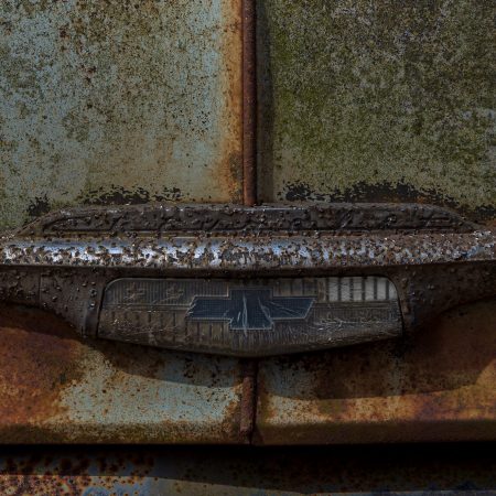 Chevrolet emblem with rust and decay.