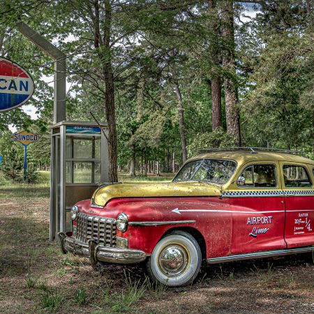 1940s Dodge Airport Limo Taxi cab with hood ornament and rate chart on passenger door.