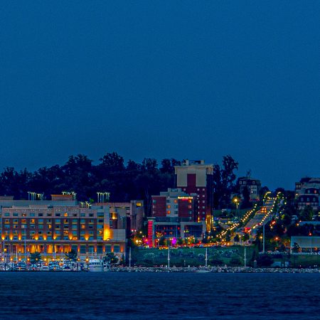 Pink Supermoon at National Harbor with Ferris wheel and illuminated cityscape