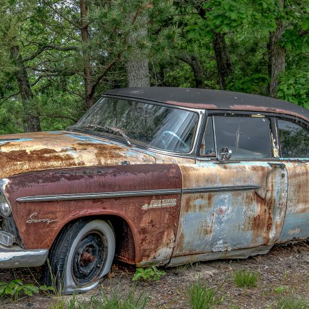 1950s Plymouth Savoy with multicolored rust and paint patina.