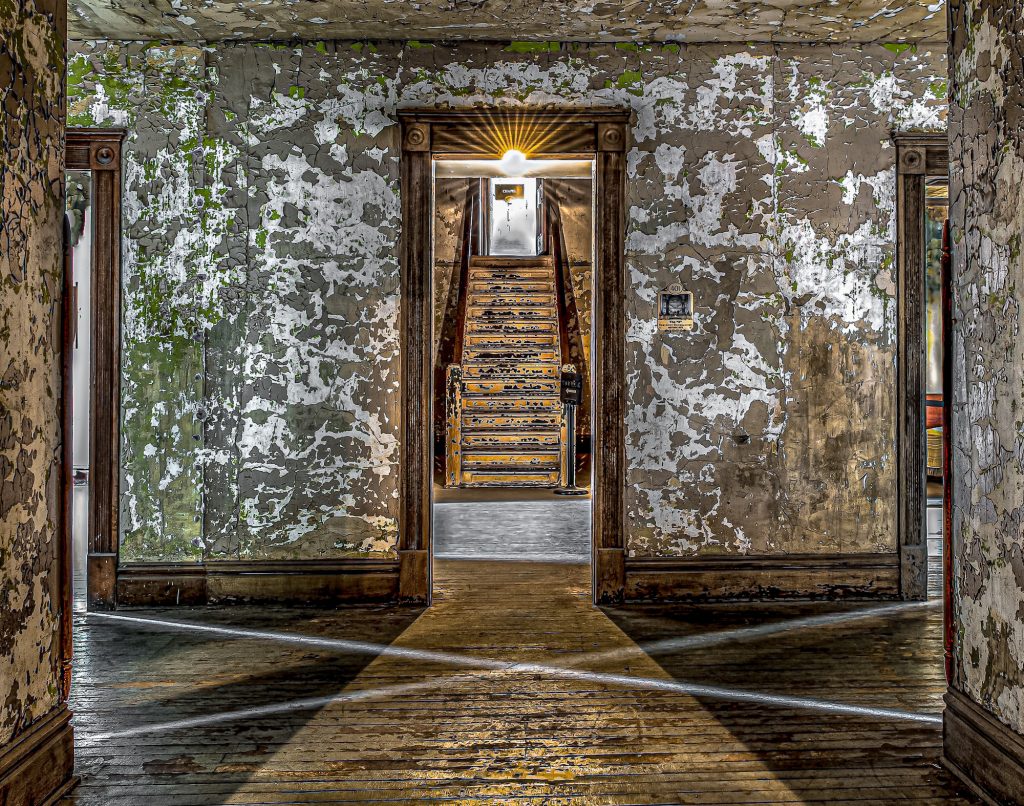 Abandoned Ohio State Reformatory Chapel Staircase with staircase, peeling paint and light manipulations.