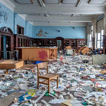 Abandoned Vo Tech School Library with library books strewn about.