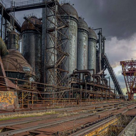 The rusted catwalk, train trestle, hot stoves and iron ore conveyor of US Steel's Carrie Blast Furnaces with the gantry crane in the background.