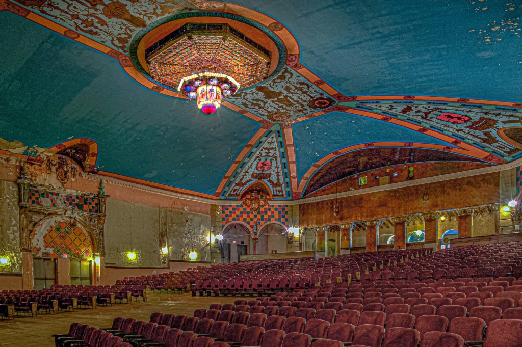 Abandoned Lansdowne Philadelphia theater with chandelier, seating and murals.