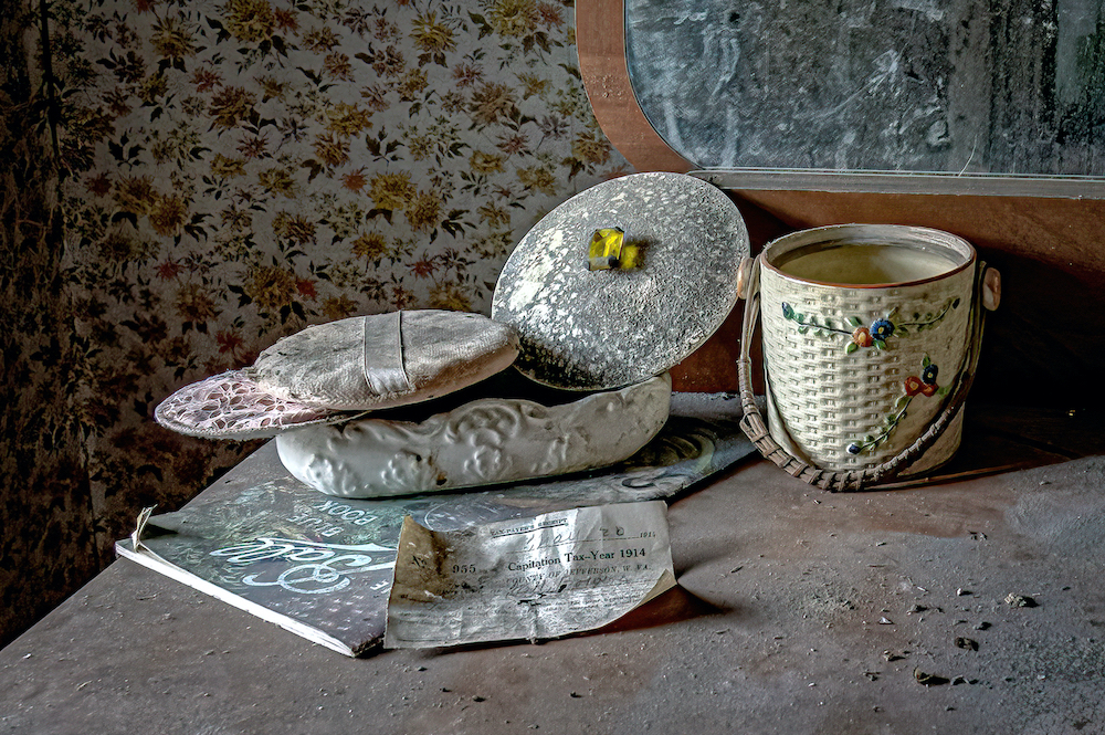 Abandoned farmhouse bedroom dresser with powder puff and 1914 capitation tax or poll tax receipt.