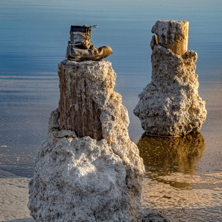 Abandoned boot on salt-crusted dock remnants at Bombay Beach, Salton Sea, California.