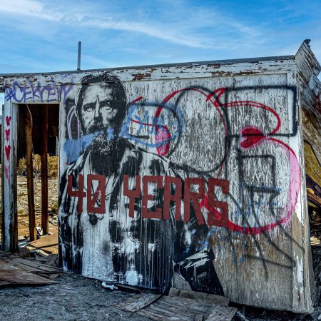 The remains of a Salton City housing community on the Salton Sea with Kevin Costtner's Waterworld personna graffitied on a structure.