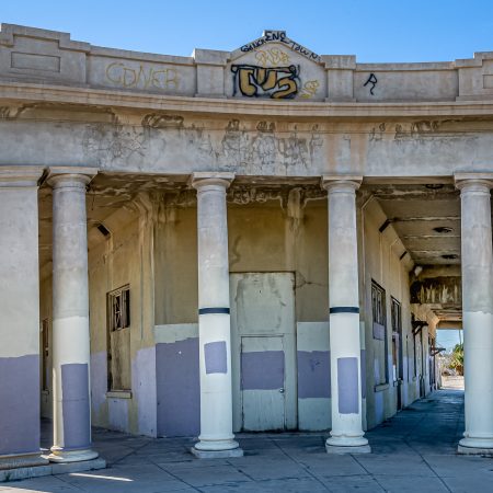 A large bank was once a busy center of exhange for the Niland California residents but now is vacant and graffitied.