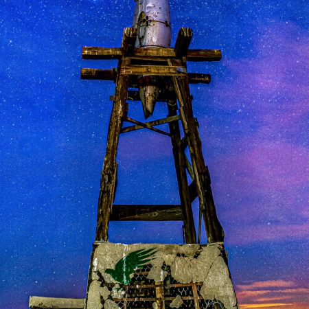 Artist installAbandoned boot on salt-crusted pier remnant at Bombay Beach, Salton Sea, California.