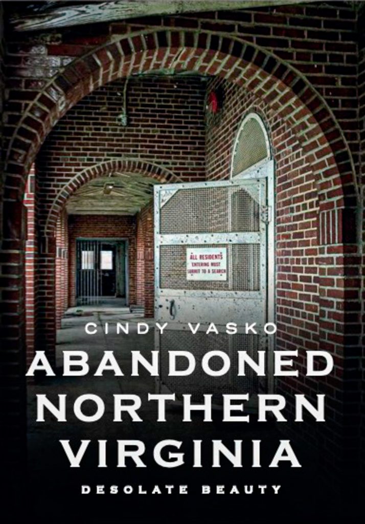 Abandoned Northern Virginia is a compilation of photography of derelict sites including the cover's prison corridor with brick arches and steel barred doors.